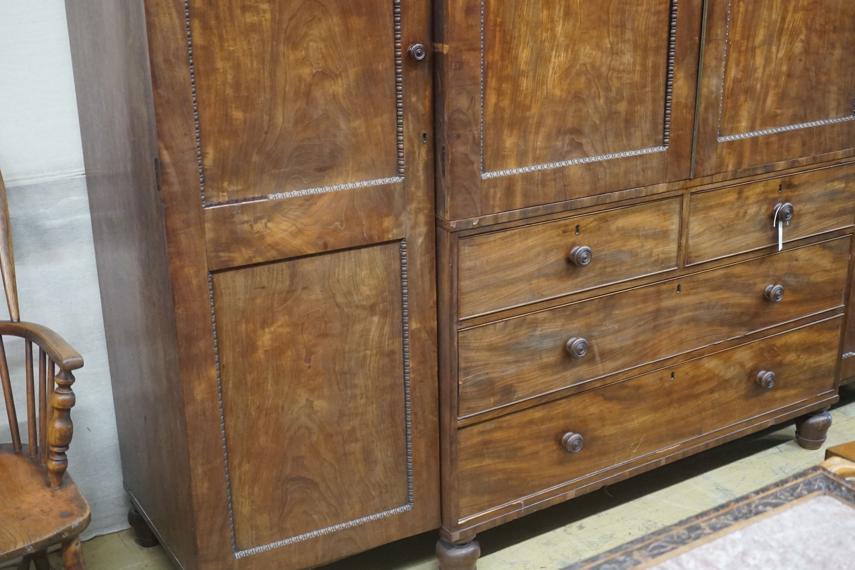 A George IV flamed mahogany break-front wardrobe, length 244cm, depth 60cm, height 195cm